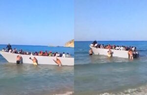 Toeristen op Grieks eiland duwen een boot vol met vluchtelingen weer terug de zee in